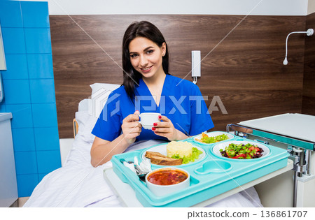 Tray with breakfast for the young female patient.  136861707