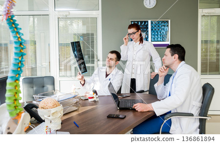 Doctors team having medical council in hospital. Doctors team having medical council in hospital. 136861894