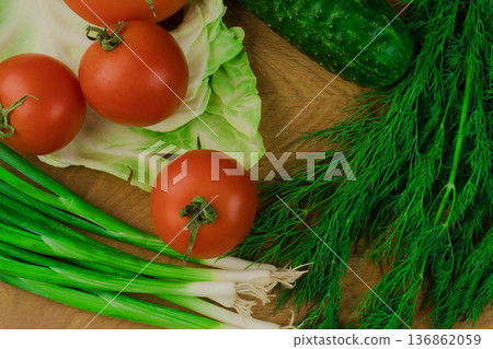 Fresh vegetables on a chopping wooden board, about to turn into a salad. Fresh vegetables on a chopping wooden board, about to turn into a salad. 136862059