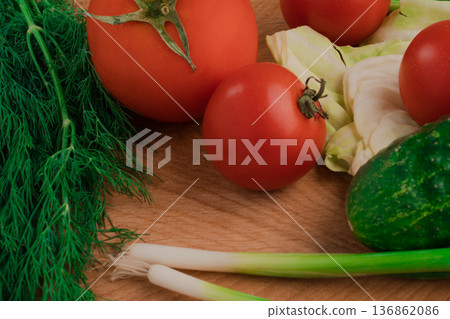 Fresh vegetables for salad on a cutting wooden board Fresh vegetables for salad on a cutting wooden board 136862086