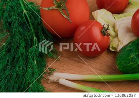 Fresh vegetables for salad on a cutting wooden board Fresh vegetables for salad on a cutting wooden board 136862087