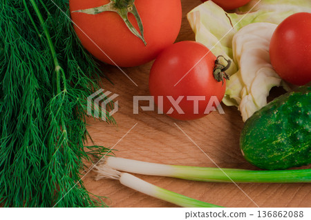 Fresh vegetables for salad on a cutting wooden board Fresh vegetables for salad on a cutting wooden board 136862088