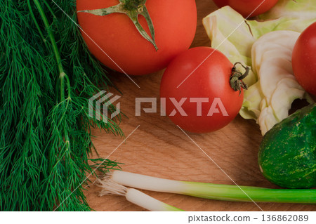 Spring vitamin set of various green leafy vegetables on a wooden board. 136862089