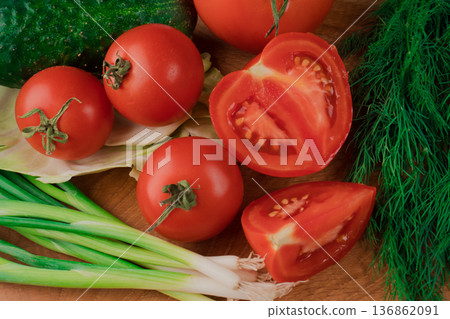 Spring vitamin set of various green leafy vegetables on a wooden board. 136862091