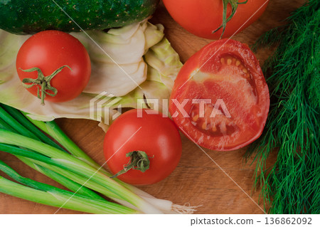Spring vitamin set of various green leafy vegetables on a wooden board. 136862092