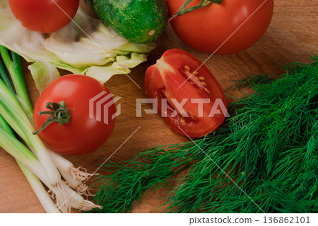 Spring vitamin set of various green leafy vegetables on a wooden board. Spring vitamin set of various green leafy vegetables on a wooden board. 136862101