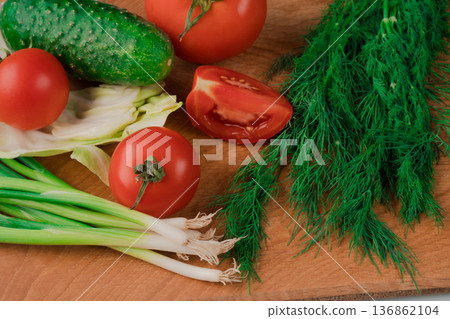 Nutrients are ideal for a delicious salad of fresh vegetables on a wooden board. Nutrients are ideal for a delicious salad of fresh vegetables on a wooden board. 136862104