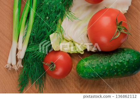 Nutrients are ideal for a delicious salad of fresh vegetables on a wooden board. Nutrients are ideal for a delicious salad of fresh vegetables on a wooden board. 136862112