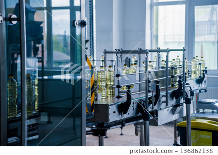 Bottling line of sunflower oil in bottles. Vegetable oil production plant. Bottling line of sunflower oil in bottles. Vegetable oil production plant. 136862138