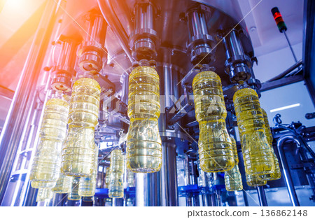 Bottling line of sunflower oil in bottles. Vegetable oil production plant Bottling line of sunflower oil in bottles. Vegetable oil production plant 136862148