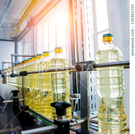 Bottling line of sunflower oil in bottles. Vegetable oil production plant 136862150