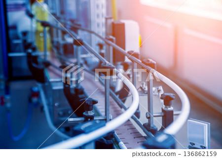 Bottling line of sunflower oil in bottles. Vegetable oil production plant. Bottling line of sunflower oil in bottles. Vegetable oil production plant. 136862159