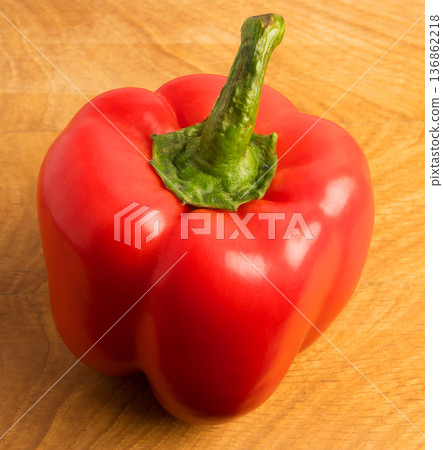 red sweet pepper on a wooden board 136862218