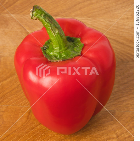 red sweet pepper on a wooden board 136862220