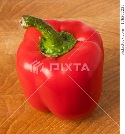red sweet pepper on a wooden board red sweet pepper on a wooden board 136862223