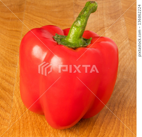 red sweet pepper on a wooden board red sweet pepper on a wooden board 136862224