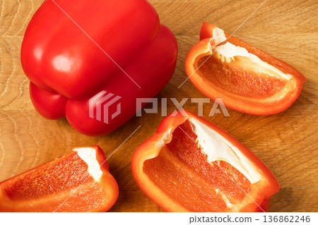 Sweet pepper whole and slices on a wooden board Sweet pepper whole and slices on a wooden board 136862246