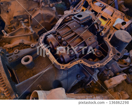 Rusted engine parts and corroded gears scattered across the sandy ground Rusted engine parts and corroded gears scattered across the sandy ground 136862298