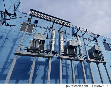 Condenser units with piping and panels on urban building wall Condenser units with piping and panels on urban building wall 136862303