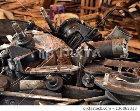 Pile of rusted motor components and gears in cluttered scrap heap 136862318