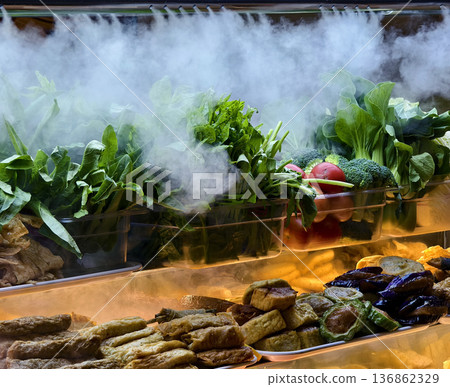 foggy refrigeration creating display with leafy greens and eggplants in glass case foggy refrigeration creating display with leafy greens and eggplants in glass case 136862329