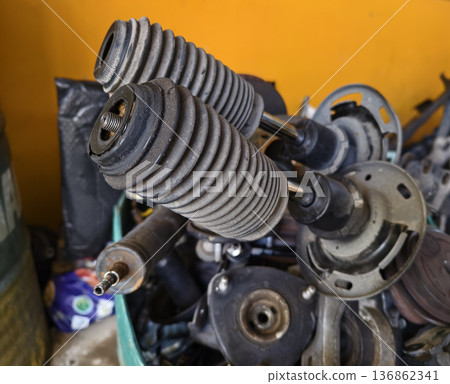 Pile of rusted motor components and gears in cluttered scrap heap 136862341