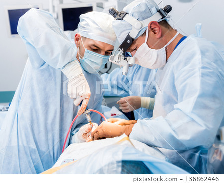 Spinal surgery. Group of surgeons in operating room with surgery equipment. Spinal surgery. Group of surgeons in operating room with surgery equipment. 136862446
