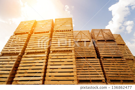 Wooden boxes stacked on each other. Outdoors. Blue sky background Wooden boxes stacked on each other. Outdoors. Blue sky background 136862477