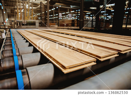 Production line of the wooden floor factory. CNC automatic woodworking machine. Production line of the wooden floor factory. CNC automatic woodworking machine. 136862530