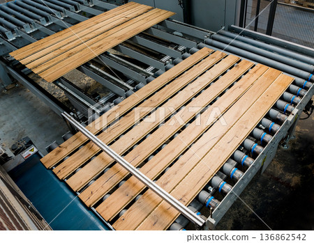 Production line of the wooden floor factory. CNC automatic woodworking machine. 136862542