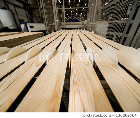 Production line of the wooden floor factory. CNC automatic woodworking machine. Production line of the wooden floor factory. CNC automatic woodworking machine. 136862564