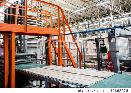 Production line of the wooden floor factory. CNC automatic woodworking machine. 136862576