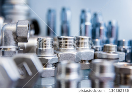 Hosepipe fittings on the table. Plumbing pipeline spare parts. 136862586