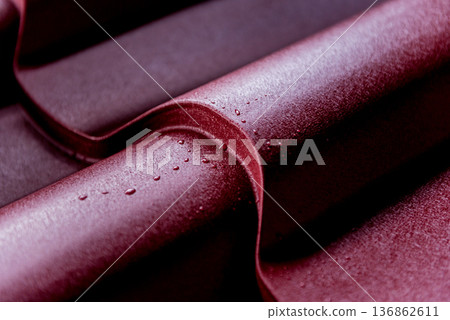Red metallic roof tiles background with drops of water. 136862611