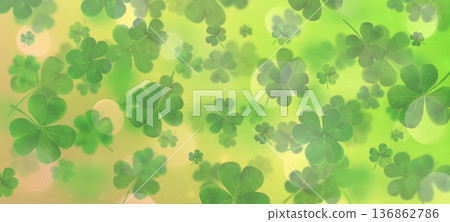 Scattered clover leaves on a blurred green gradient background with light bokeh. St. Patrick's Day Scattered clover leaves on a blurred green gradient background with light bokeh. St. Patrick's Day 136862786