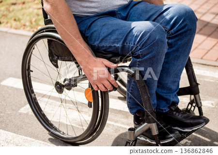 Handicapped man in wheelchair walk at the park alley 136862846