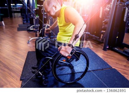Disabled man training in the gym of rehabilitation center 136862891