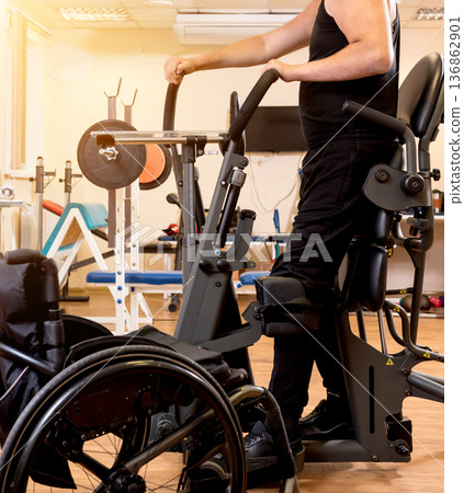 Disabled man training in the gym. Rehabilitation center 136862901