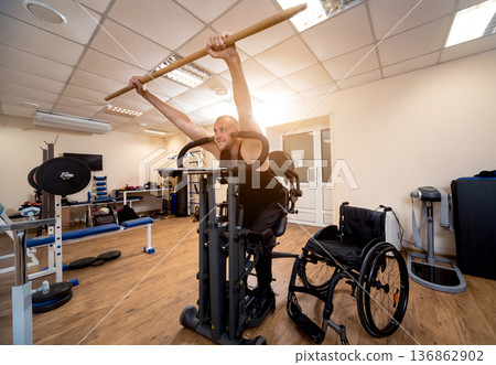 Disabled man training in the gym. Rehabilitation center Disabled man training in the gym. Rehabilitation center 136862902