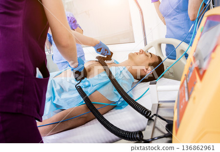 Doctors give resuscitation to a male patient in the emergency room. 136862961