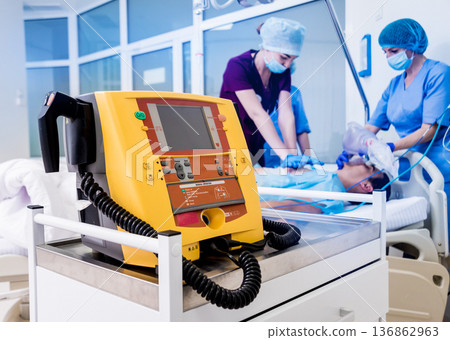 Doctors give resuscitation to a male patient in the emergency room. 136862963