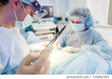 Spinal surgery. Group of surgeons in operating room with surgery equipment. Spinal surgery. Group of surgeons in operating room with surgery equipment. 136862965