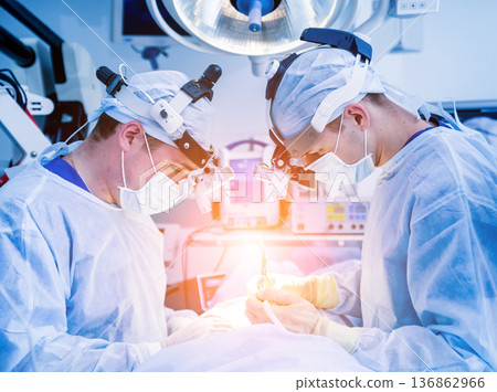 Spinal surgery. Group of surgeons in operating room with surgery equipment.  136862966