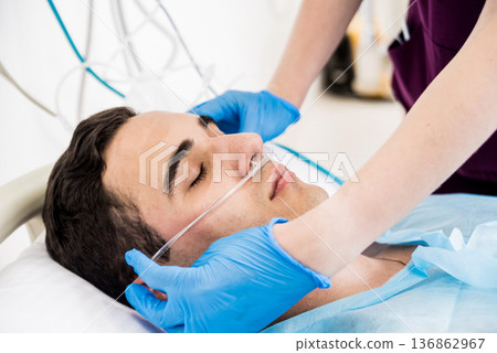 Doctors give resuscitation to a male patient in the emergency room. 136862967