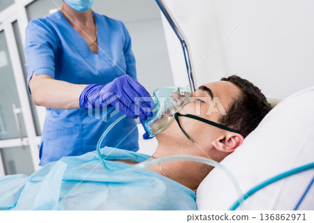 Doctors give resuscitation to a male patient in the emergency room. Doctors give resuscitation to a male patient in the emergency room. 136862971
