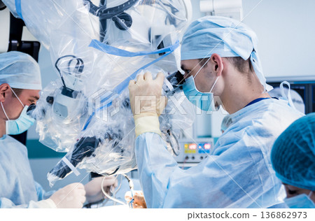 Spinal surgery. Group of surgeons in operating room with surgery equipment.  136862973