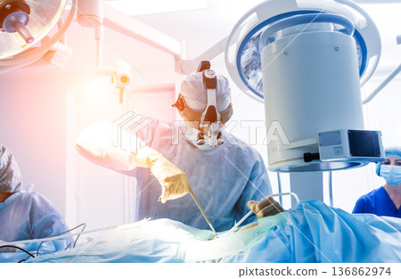 Spinal surgery. Group of surgeons in operating room with surgery equipment. Spinal surgery. Group of surgeons in operating room with surgery equipment. 136862974