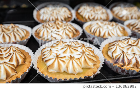 Delicious meringue pie on table, closeup. French lemon tart with churned meringue Delicious meringue pie on table, closeup. French lemon tart with churned meringue 136862992