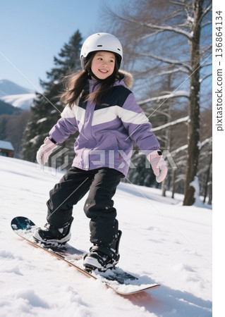 Happy girl playing on snowboard Happy girl playing on snowboard 136864134