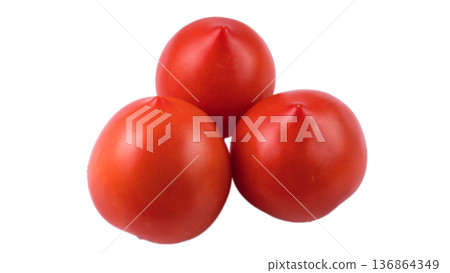 Three whole tomatoes on a white background in isolation Three whole tomatoes on a white background in isolation 136864349